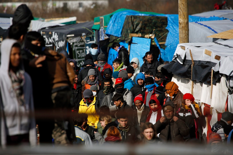 Migrants and activists at the Calais camp (AP Photo/Jerome Delay)